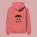 Product shot showing the back view of a peach-colored pullover hoodie. It features a black streetwear graphic print of a stylized face with a mustache and curly hair above Japanese characters, directly replicating Momo's hoodie from the Dan Da Dan anime.