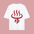 Flat lay mockup showing the back of a white short-sleeve t-shirt against a pink background. It features a bold red graphic of a Japanese hot spring symbol with the hiragana character 'yu' beneath it, inspired by the Dan Da Dan anime.