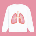 Flat product mockup showing the back of a white crewneck sweatshirt. The design features a stylized, pastel pink and red anatomical illustration of human lungs centered on the back.