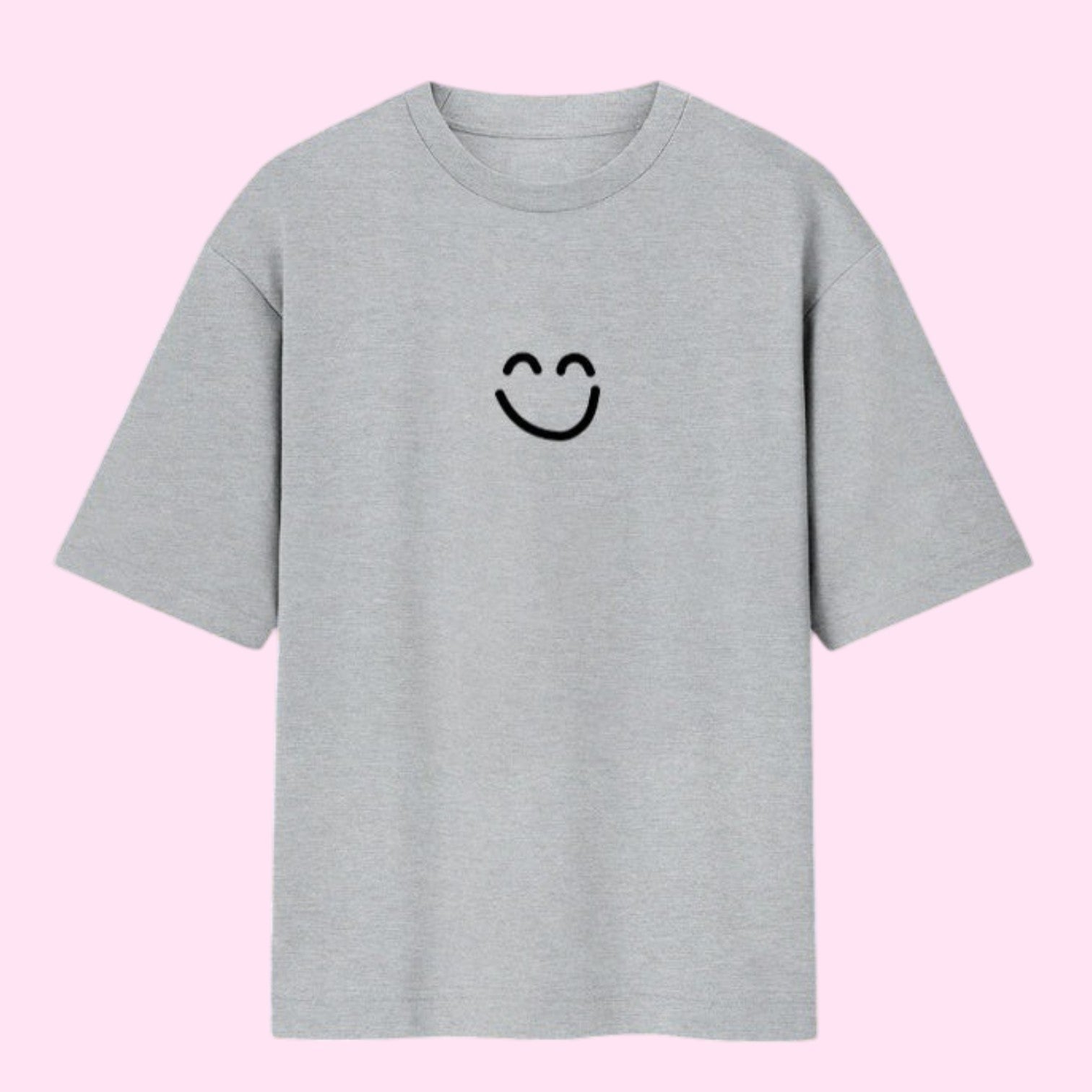 Front view of a flat light grey oversized streetwear t-shirt featuring Momo Ayase's black smiley face graphic from Dan Da Dan Season 1.